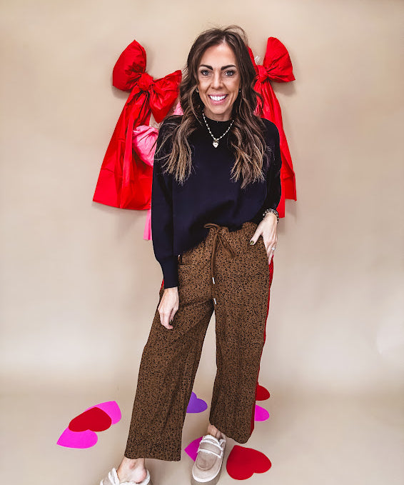 Dark mustard and black leo drawstring waist pants with wide leg.
