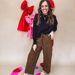 Dark mustard and black leo drawstring waist pants with wide leg.