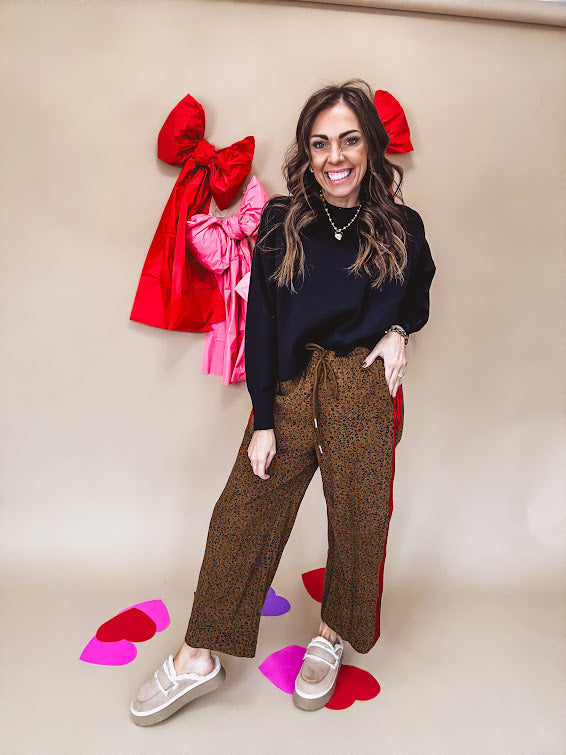 Dark mustard and black leo drawstring waist pants with wide leg.