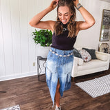 Medium wash midi skirt featuring light and dark wash details throughout with a button and zipper closure and elastic back waist, high front split, side pockets and an upside down design on the bottom. 