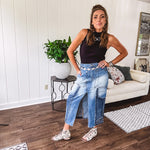 Medium wash midi skirt featuring light and dark wash details throughout with a button and zipper closure and elastic back waist, high front split, side pockets and an upside down design on the bottom. 