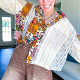 Short hem cotton long sleeved top with boho floral pint patchwork throughout and lace inserts and front pocket with silver button front, Earth tones.