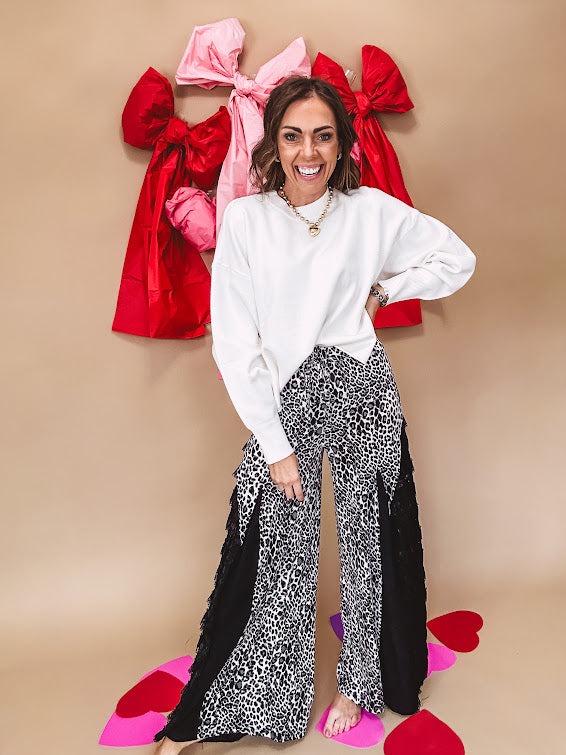 Round neck, crew style cropped sweater with drop shoulder available in black, white and wine.