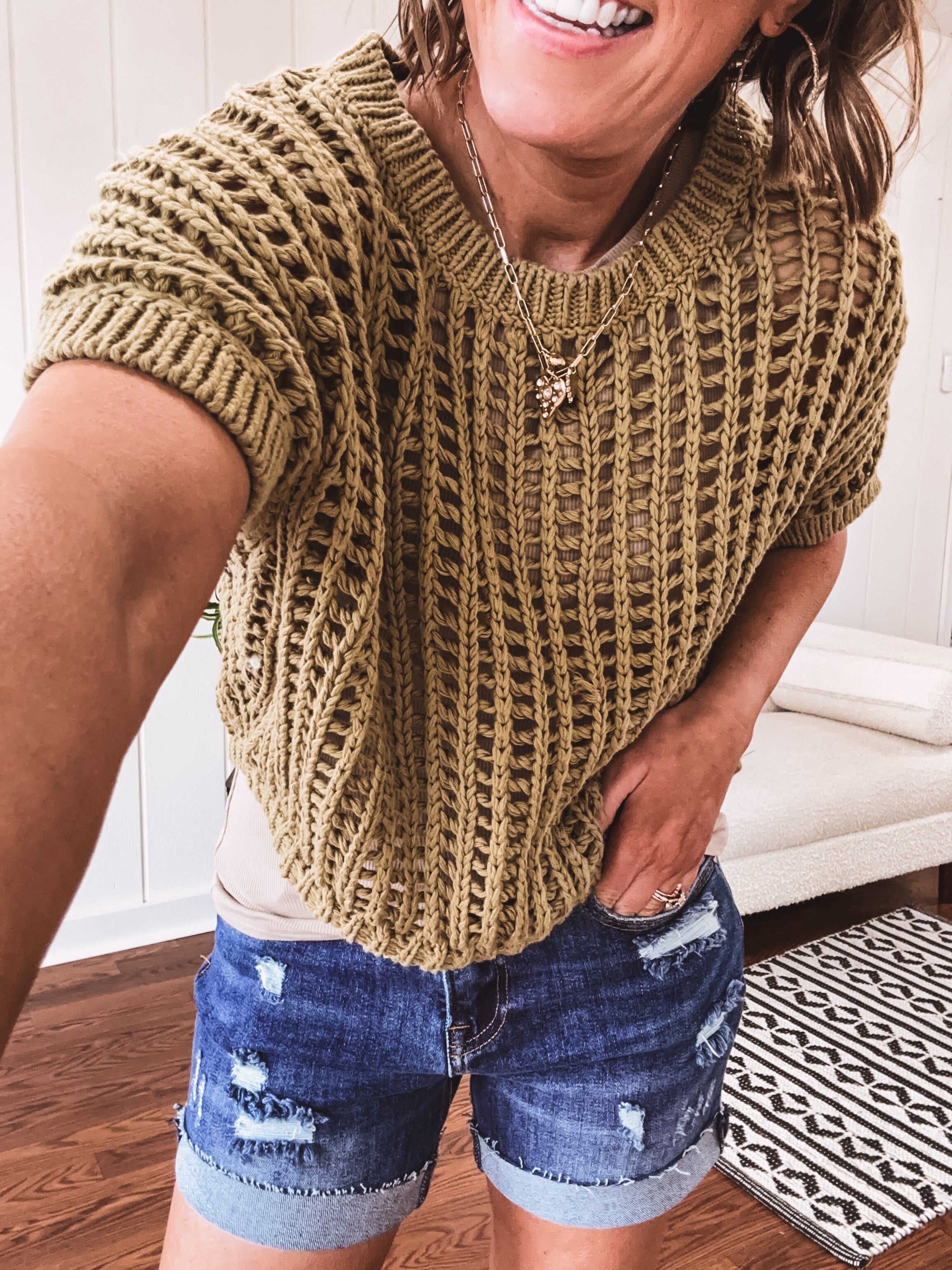 Open weave short sleeved waist length sweater available in many colors.