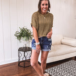 Open weave short sleeved waist length sweater available in many colors.