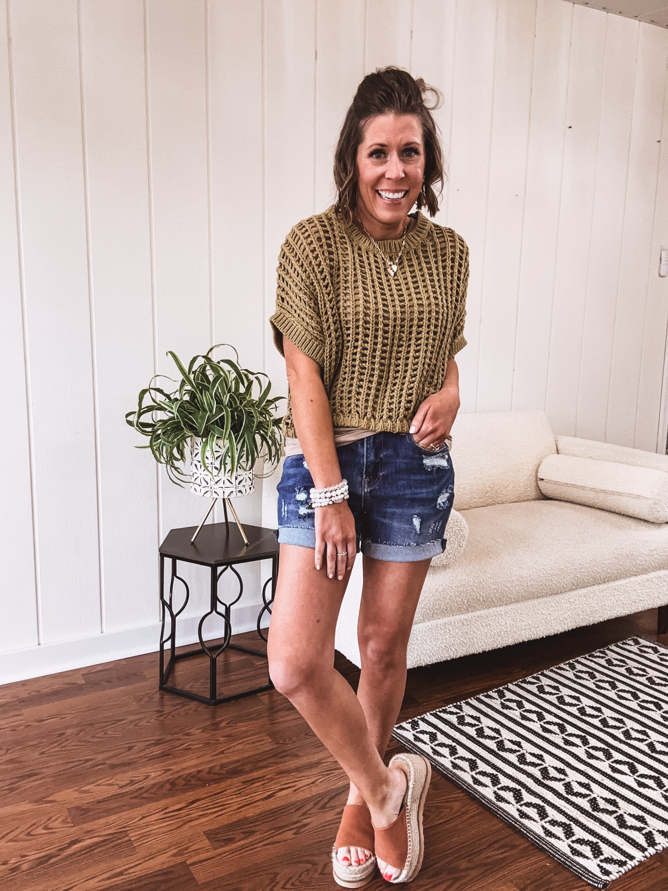 Open weave short sleeved waist length sweater available in many colors.