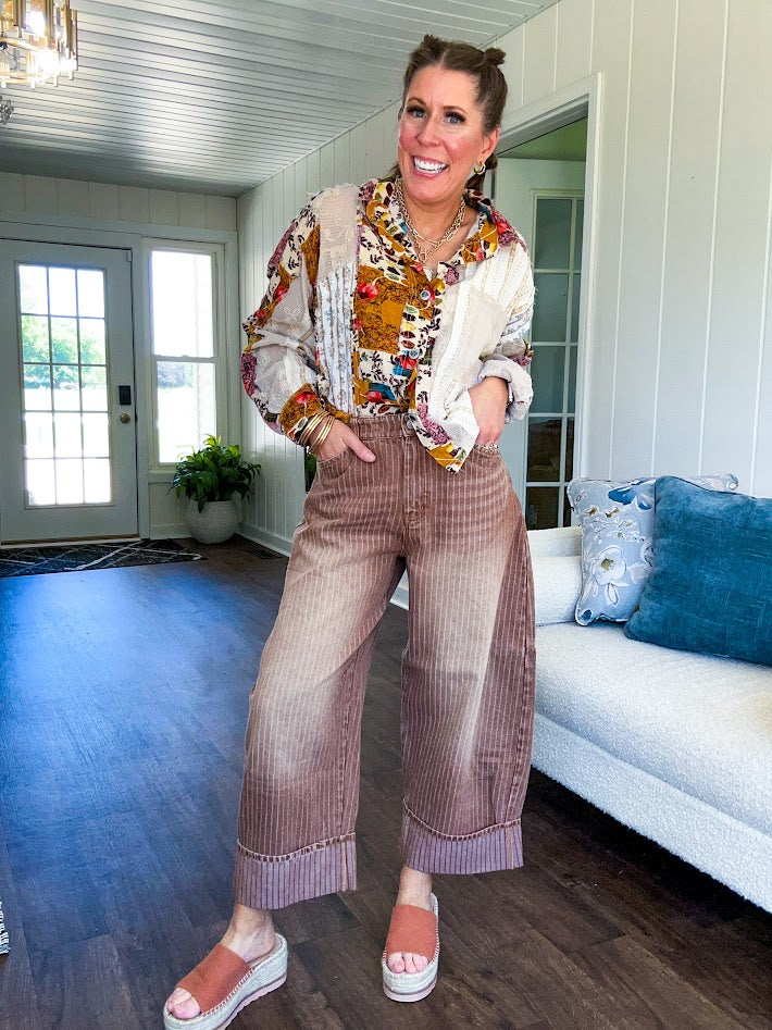 Short hem cotton long sleeved top with boho floral pint patchwork throughout and lace inserts and front pocket with silver button front, Earth tones.