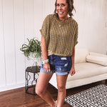 Open weave short sleeved waist length sweater available in many colors.