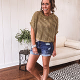 Open weave short sleeved waist length sweater available in many colors.