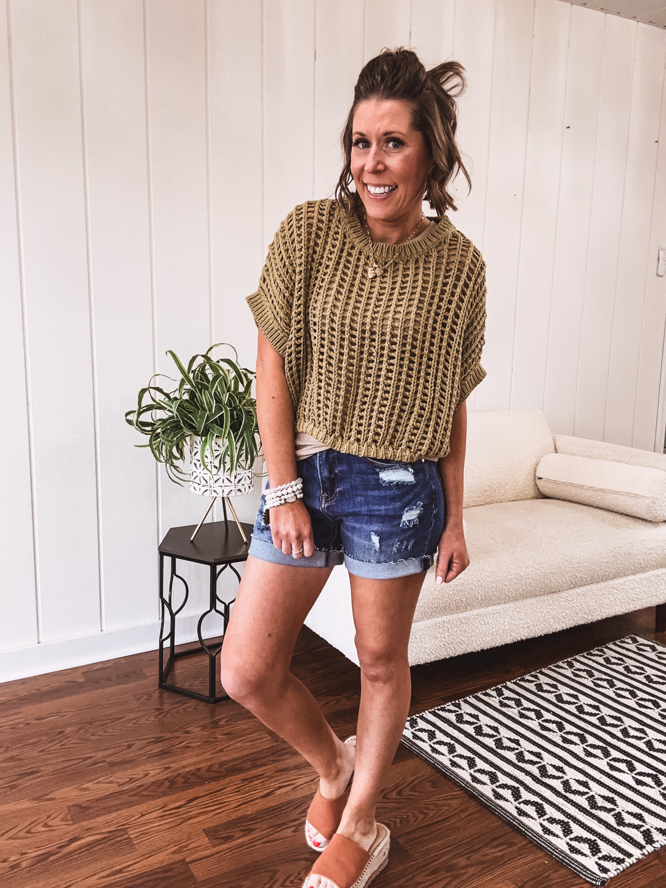 Open weave short sleeved waist length sweater available in many colors.