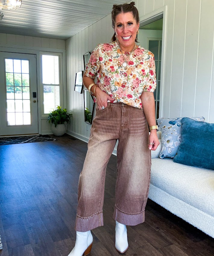 Thin, lightweight washed brown denim with light pinstriping, button and zipper closure, side and back pockets and wide cuffs. 