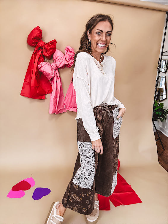 Drop shoulder three button round neck long sleeved top.
