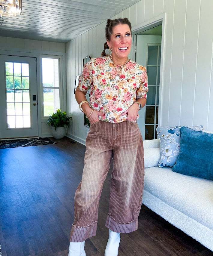 Thin, lightweight washed brown denim with light pinstriping, button and zipper closure, side and back pockets and wide cuffs. 