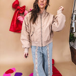 Tan puffer bomber jacket with zipper front and side pockets.