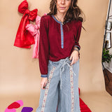 Burgundy Henley style long sleeved top with denim trim at 1/4 button down front, collar and cuffs.
