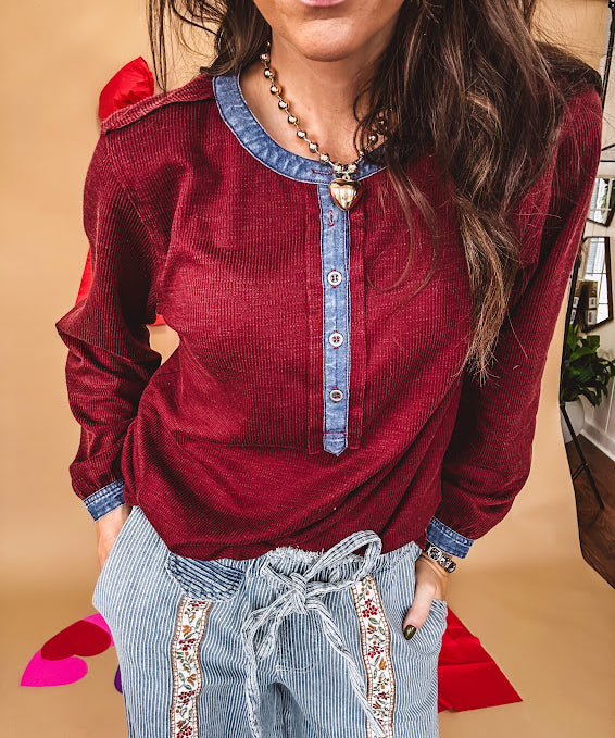 Burgundy Henley style long sleeved top with denim trim at 1/4 button down front, collar and cuffs.