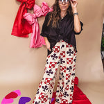 Cream wide leg pants with a spice and chocolate playing card motif pattern, elastic back waist and functional side pockets.