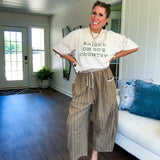 Lightweight mocha utility pant with textured darker mocha striping and contrasting tan and cream mini striping at the elastic drawstring waist and trim on the oversized pocket.