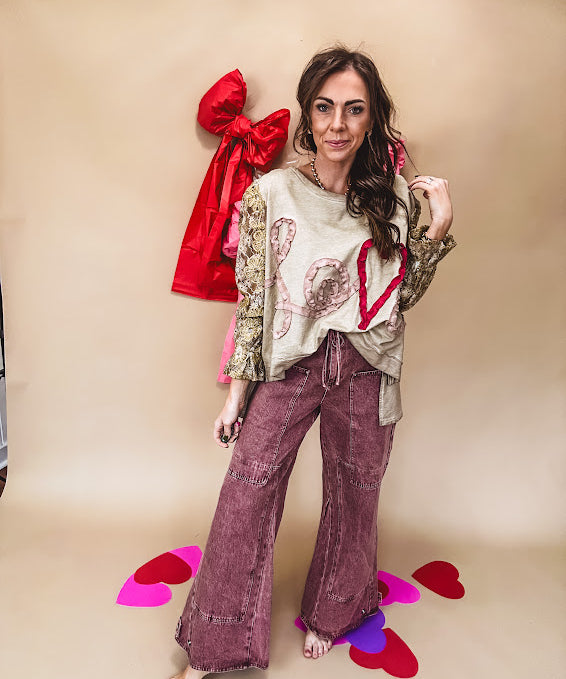 Washed wine colored wide leg cargo pants with drawstring waist.
