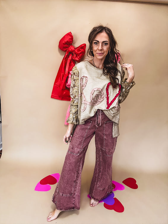 Washed wine colored wide leg cargo pants with drawstring waist.