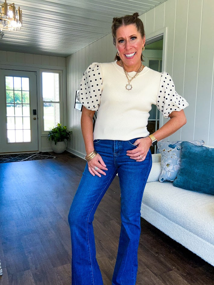 Ivory ribbed round neck short sleeved top with balloon sleeves featuring black polka dots, with a scalloped hem and neckline.