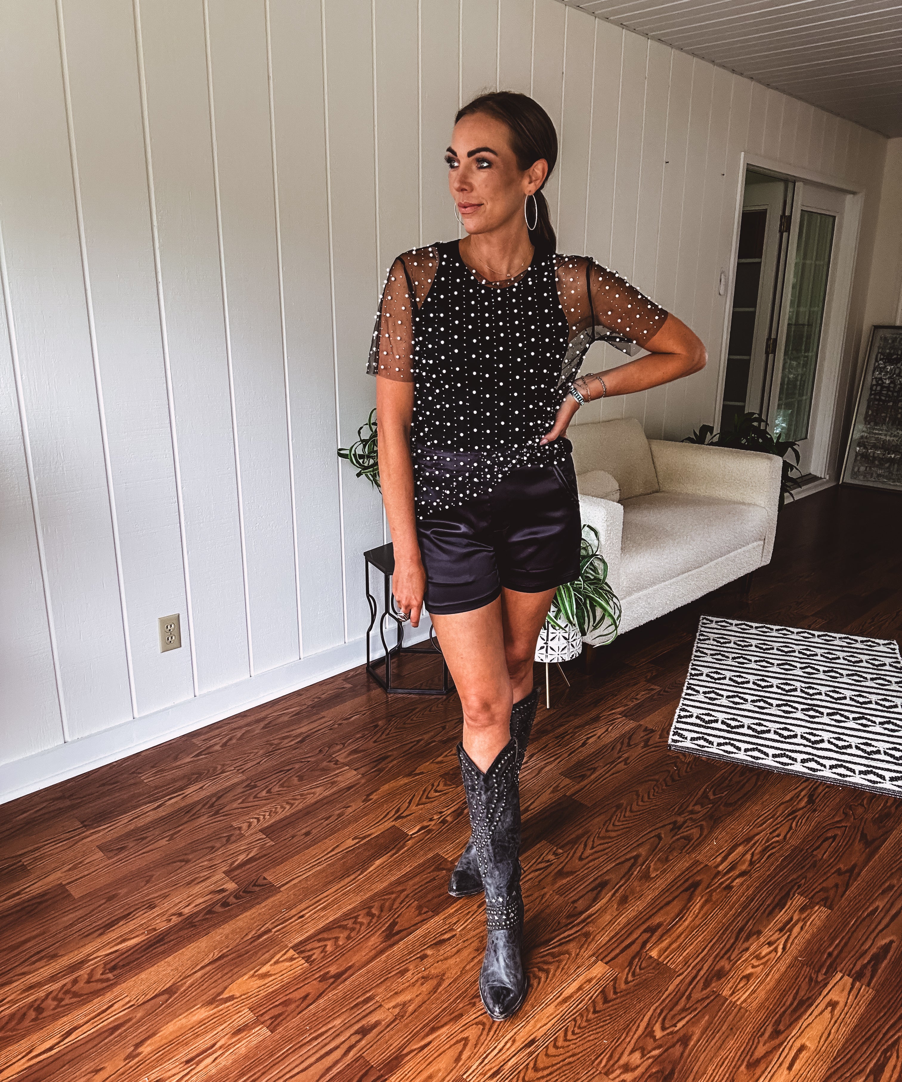 Black satin shorts with an elastic waist and western inspired pockets in a tuxedo style.