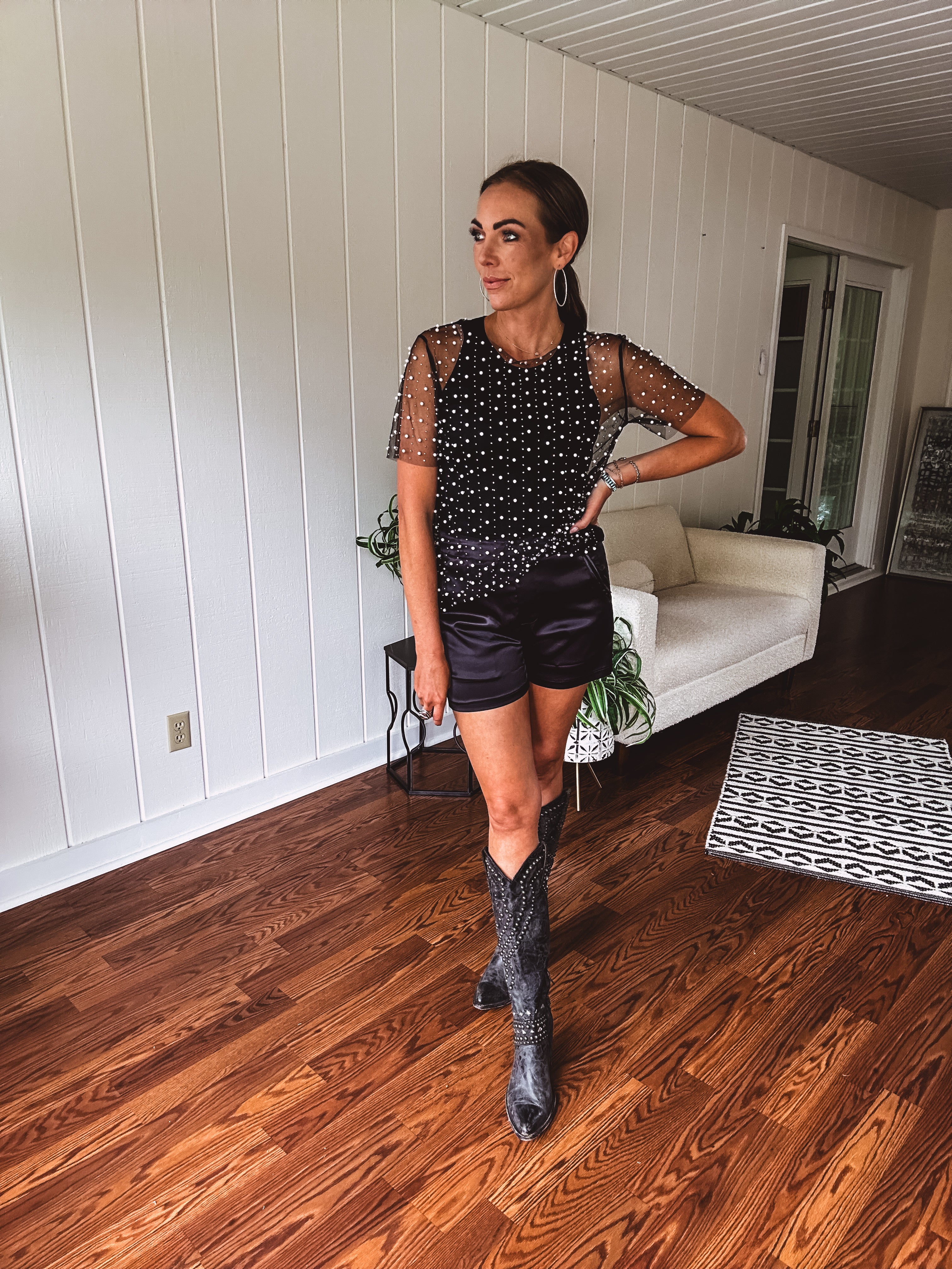 Black satin shorts with an elastic waist and western inspired pockets in a tuxedo style.