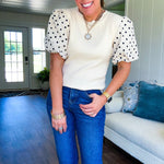 Ivory ribbed round neck short sleeved top with balloon sleeves featuring black polka dots, with a scalloped hem and neckline.