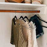 Open weave short sleeved waist length sweater available in many colors.