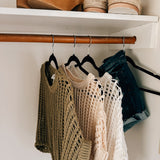 Open weave short sleeved waist length sweater available in many colors.