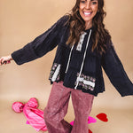 Black washed empire waist hoodie with green and pink floral embroidery and lace down the sleeves, on the patchwork and on the back