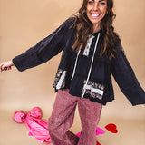 Black washed empire waist hoodie with green and pink floral embroidery and lace down the sleeves, on the patchwork and on the back