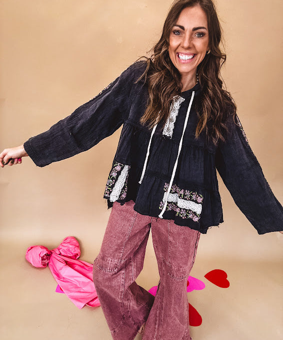 Black washed empire waist hoodie with green and pink floral embroidery and lace down the sleeves, on the patchwork and on the back