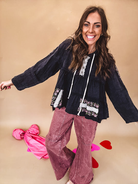 Black washed empire waist hoodie with green and pink floral embroidery and lace down the sleeves, on the patchwork and on the back