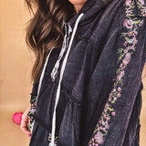 Black washed empire waist hoodie with green and pink floral embroidery and lace down the sleeves, on the patchwork and on the back