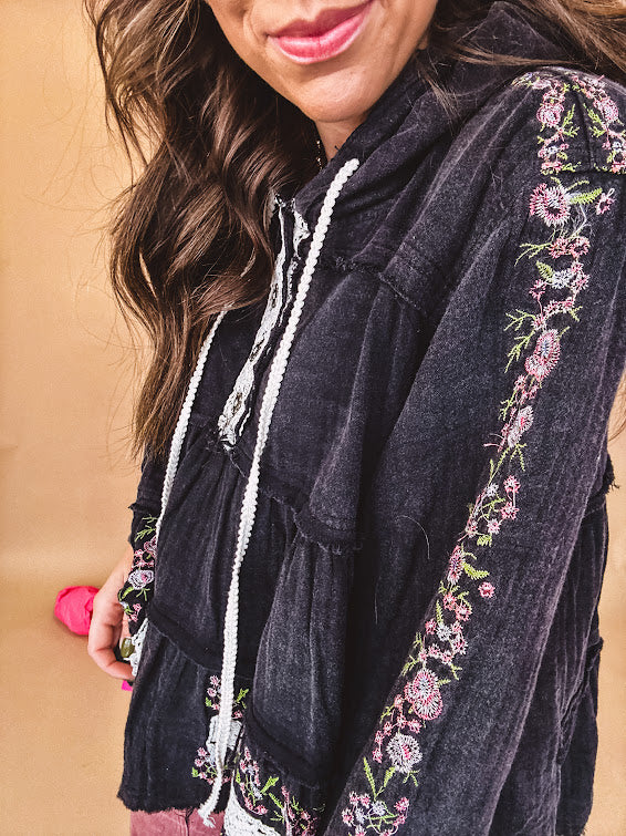 Black washed empire waist hoodie with green and pink floral embroidery and lace down the sleeves, on the patchwork and on the back