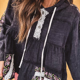 Black washed empire waist hoodie with green and pink floral embroidery and lace down the sleeves, on the patchwork and on the back