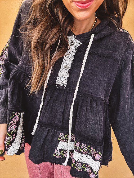 Black washed empire waist hoodie with green and pink floral embroidery and lace down the sleeves, on the patchwork and on the back