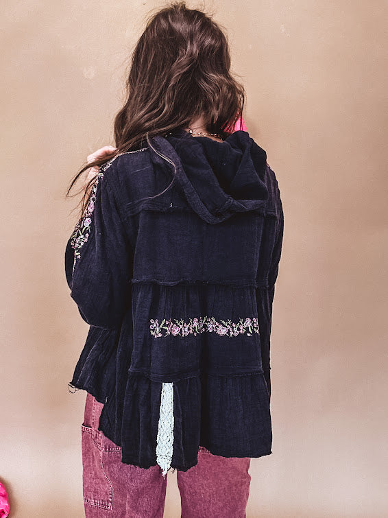 Black washed empire waist hoodie with green and pink floral embroidery and lace down the sleeves, on the patchwork and on the back