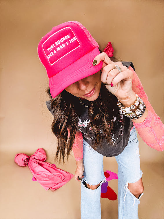 Neon pink puffy trucker hat with "That Sounds Like A Man's Job" in white embroidery.