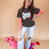 Charcoal cotton tee with pink, teal, white and red and "Howdy", cherries and a white and black checkered lightning bolt graphics.