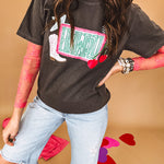 Charcoal cotton tee with pink, teal, white and red and "Howdy", cherries and a white and black checkered lightning bolt graphics.