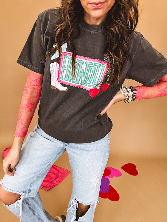 Charcoal cotton tee with pink, teal, white and red and "Howdy", cherries and a white and black checkered lightning bolt graphics.