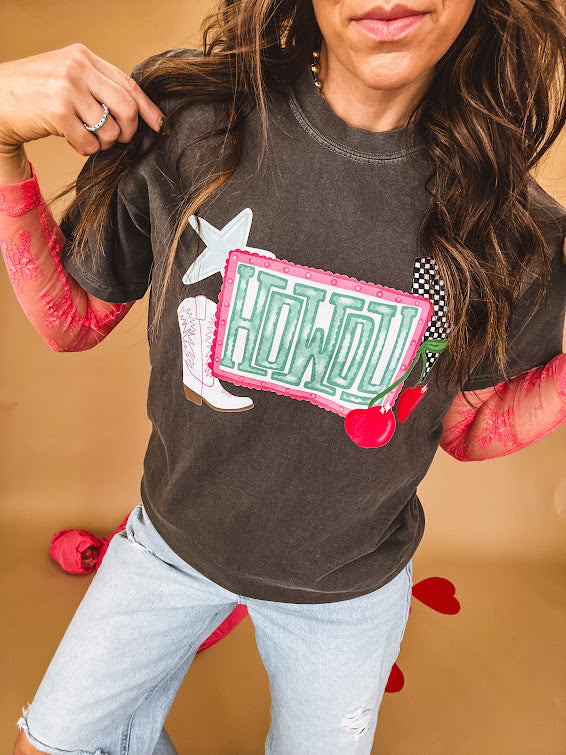 Charcoal cotton tee with pink, teal, white and red and "Howdy", cherries and a white and black checkered lightning bolt graphics.