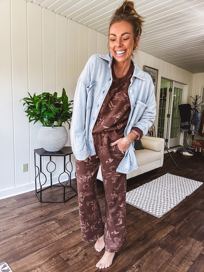 Crafted from a soft cotton-poly blend, these lightweight joggers feature an eye-catching western print complete with boots, hats, horses, and horseshoes across a warm brown base. With wide-leg silhouette, elastic drawstring waist, and functional pockets.