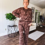 Crafted from a soft cotton-poly blend, these lightweight joggers feature an eye-catching western print complete with boots, hats, horses, and horseshoes across a warm brown base. With wide-leg silhouette, elastic drawstring waist, and functional pockets.