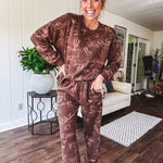 Crafted from a soft cotton-poly blend, these lightweight joggers feature an eye-catching western print complete with boots, hats, horses, and horseshoes across a warm brown base. With wide-leg silhouette, elastic drawstring waist, and functional pockets.