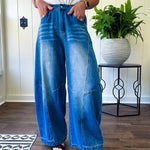 Panel Seam Jeans in Light. Featuring a bold wide-leg silhouette crafted from lightweight light denim, these jeans turn heads with their retro wash and striking contrast stitching and upside-down design at the leg openings.