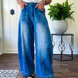 Panel Seam Jeans in Light. Featuring a bold wide-leg silhouette crafted from lightweight light denim, these jeans turn heads with their retro wash and striking contrast stitching and upside-down design at the leg openings.