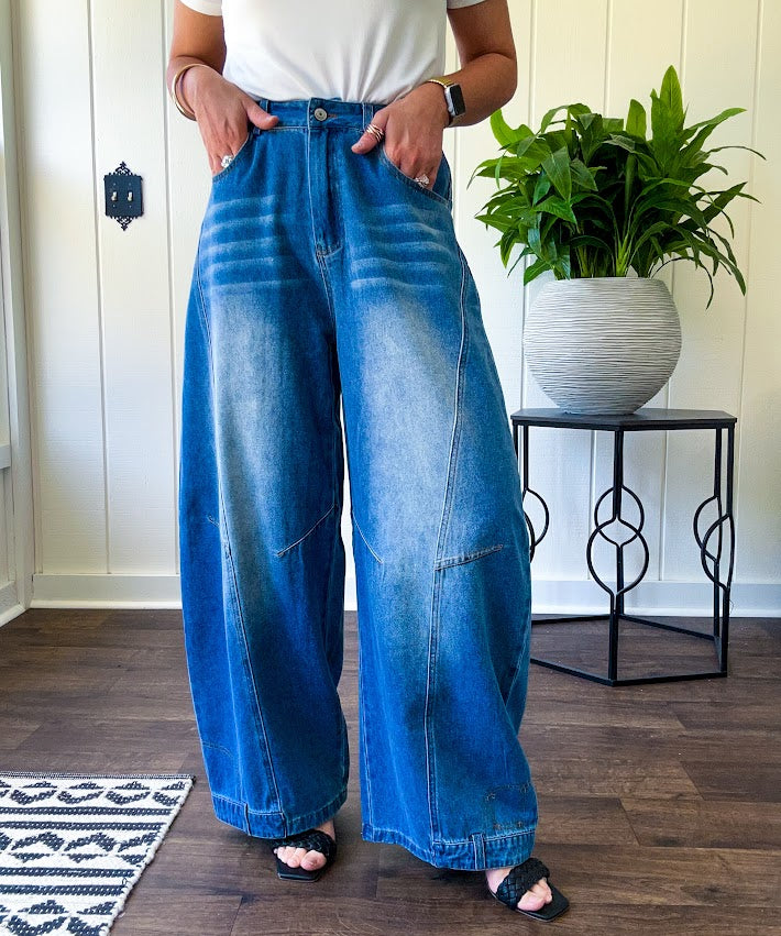 Panel Seam Jeans in Light. Featuring a bold wide-leg silhouette crafted from lightweight light denim, these jeans turn heads with their retro wash and striking contrast stitching and upside-down design at the leg openings.